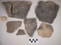 Ceramic, earthenware body, rim, and handle sherds, one with rim incised above handle, one with incised rim, one with punctate rim, some cord-impressed, some incised, cord-impressed, and punctate, one undecorated, some shell-tempered, one grit-tempered; two sherds crossmend