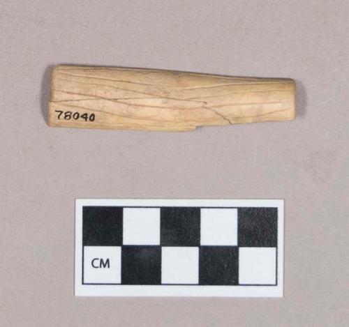 Worked animal bone fragment, likely tube fragment, incised; two fragments crossmended with glue