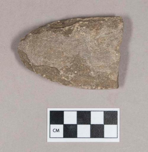 Chipped and ground stone fragment, flat, ovoid