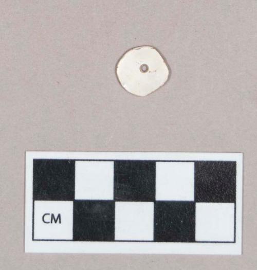 Worked shell disk, perforated, possible bead