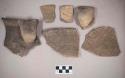 Ceramic, earthenware rim, body, and handle sherds, some incised, some cord-impressed and incised, one with molded handle, some with possible Ramie design, shell-tempered
