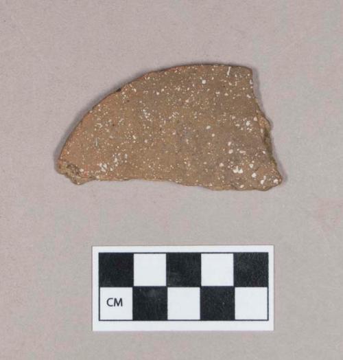 Ceramic, earthenware disk fragment, undecorated, shell-tempered