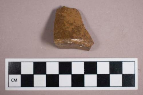 Ceramic, earthenware, light brown glazed stoneware base sherd, possible ink master fragment