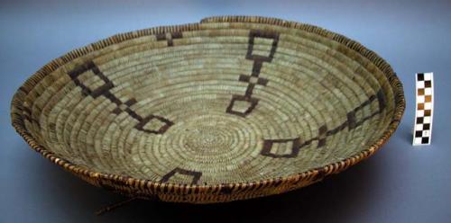 Large bowl-like basket tray. Made of yucca plant and bear grass? (dyed brown).