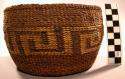 Tlingit twined basket. Tourist form with round, flat bottom. False embroidery.