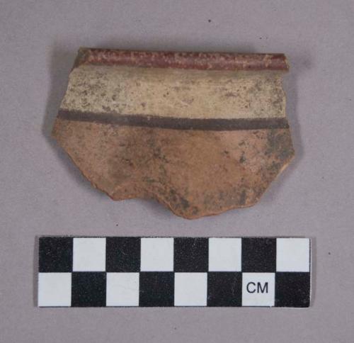 Ceramic rim sherd with polychrome designs on exterior