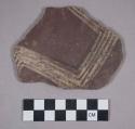 Ceramic body sherd with polychrome designs on exterior
