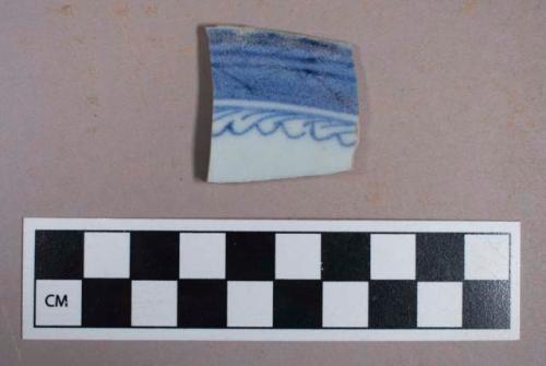 Ceramic, porcelain, soft paste, blue handpainted decoration, rim sherd