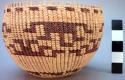 Small circular twined basket with light tan and brown geometric design bands