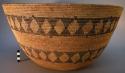 Large carrying basket with black and brown geometric designs; coil technique