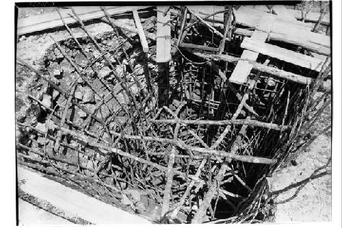 Caracol. Trench at base of upper stairway showing poles placed to prevent walls