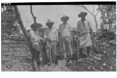 Laborers standing along upper terrace