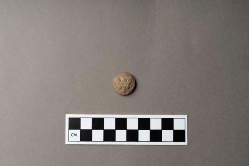 Metal, copper alloy button, embossed with eagle and shield on one side, "SCOVILLE MFG CO / WATERBURY" on reverse, missing shank