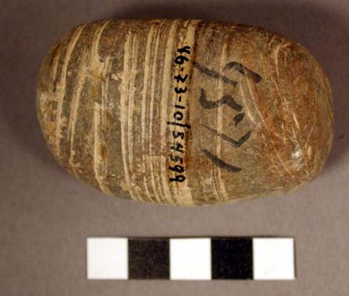 Stone ceremonial object-fetish, small banded cobble; brown-white stone; 6.7 x 4.