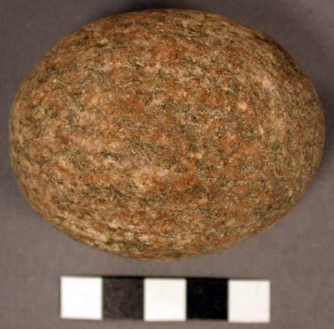 Possible pecking stone. egg-shaped, small cobble. granitic. 6.6 x 5.3 x 5.0 cm.