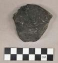 Organic groundstone, worked coal fragment