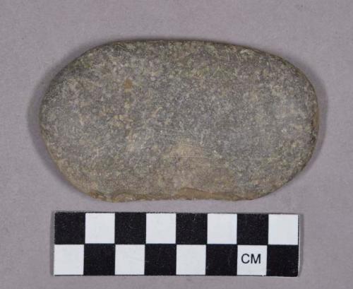 Ground stone, modified lithic, oval-shaped cobble with chipped and worn edge