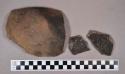 Ceramic, earthenware rim and body sherds, shell-tempered, cord-impressed and punctate; two sherds crossmend