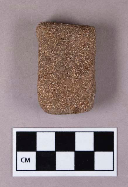 Ground stone, abrading stone fragment, grooved on both sides