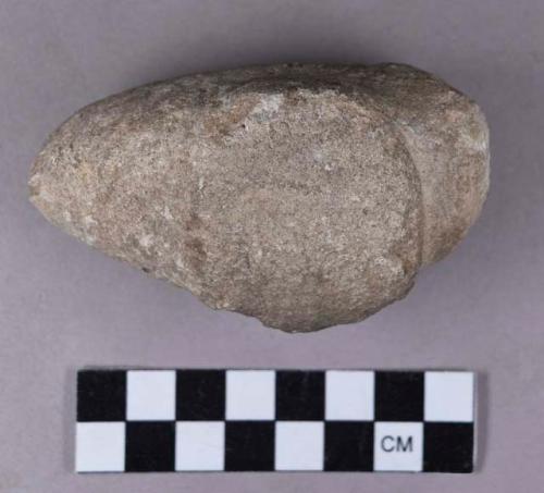 Ground stone, modified lithic, oblong, pecked object with protruding flat side