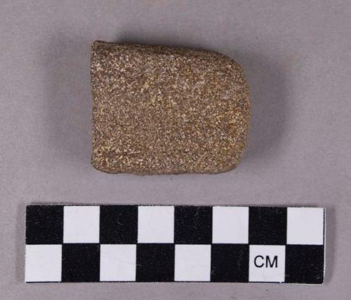 Ground stone, abrading stone fragment, grooved on both sides