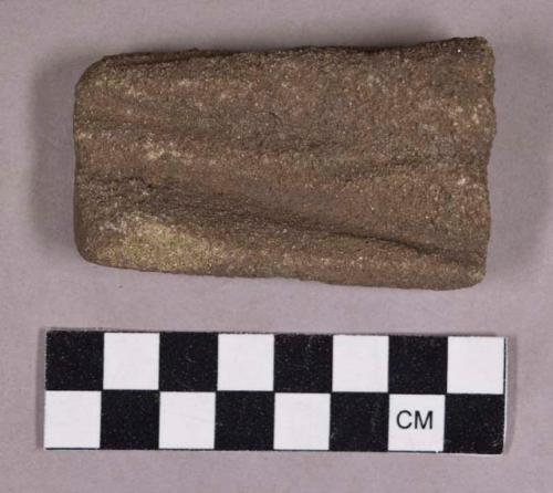 Ground stone, abrading stone fragment, grooved on both sides