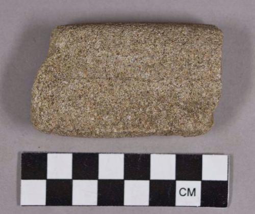 Ground stone, abrading stone fragment, lightly grooved on both sides