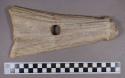 Organic, utilized antler, rectangular object with sharpened edge, perforated, mended