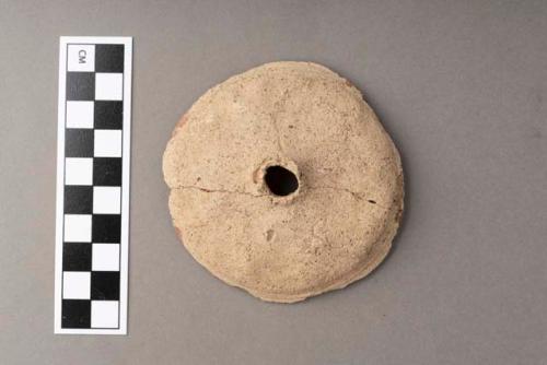 Circular potsherd - buff ware, int. red slip; use unknown