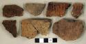 Coarse earthenware body and rim sherds, some cord impressed, some incised, some undecorated