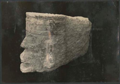 Carved stone head from bird-human panel