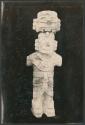 Carved stone human figure with headdress