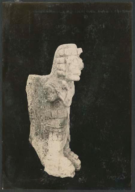 Carved stone human figure, side