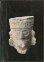 Carved stone head from bird-human panel