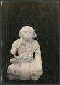 Carved stone seated human figure