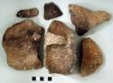 Ceramic, earthenware body, rim, and handle sherds, flared incised rim, cord-impressed body, one complete handle, three missing handles, shell-tempered; one rim sherd and thirteen body sherds crossmend