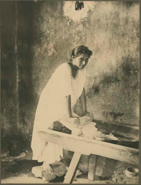 Woman grinding corn