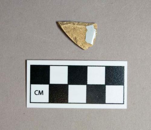 Ceramic, tin-glazed body sherd, small portion of light blue glaze on one surface