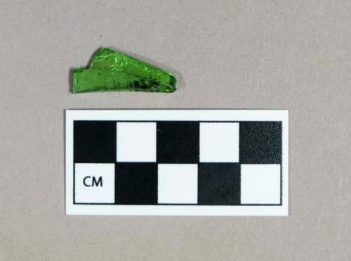 Glass, light green curved glass fragment