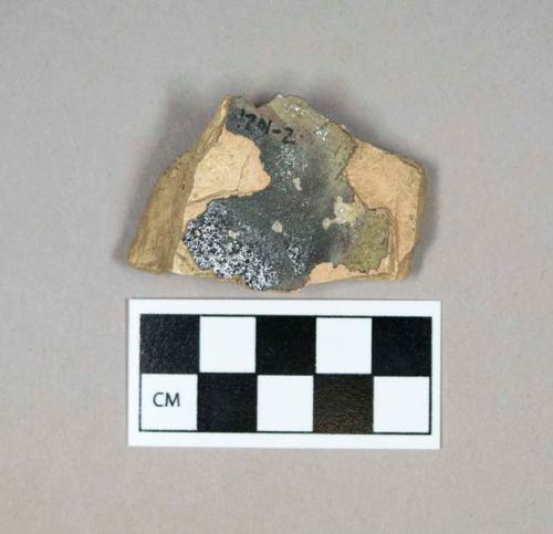 Ceramic, brown and black glazed buff bodied stoneware body sherd