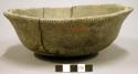 Ceramic complete vessel, bowl, incised rim, four perforated handles, mended