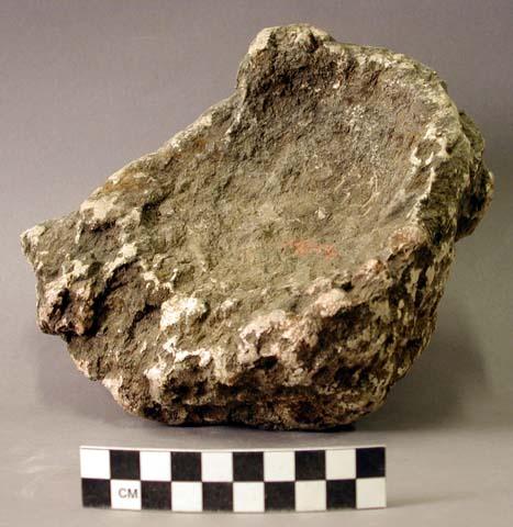 Ground stone mortar with one handle