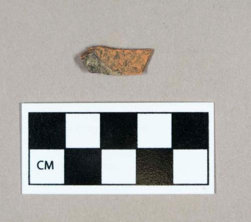 Ceramic, redware body sherd, glazed on one side, weathered/burned