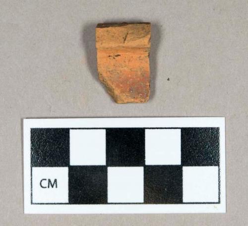 Ceramic, redware rim sherd, glazed, weathered surfaces