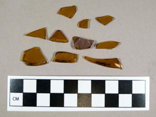 Glass, curved amber-colored fragments