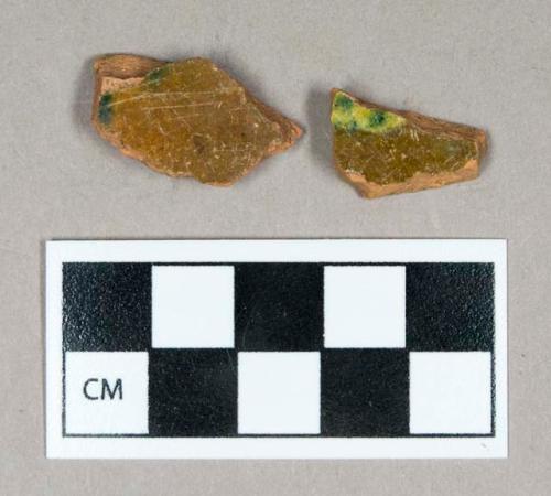 Ceramic, redware body sherds, yellow-slipped with green decoration interior, exterior surface weathered