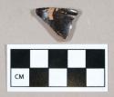 Ceramic, redware rim sherd, dark brown glaze on interior and exterior