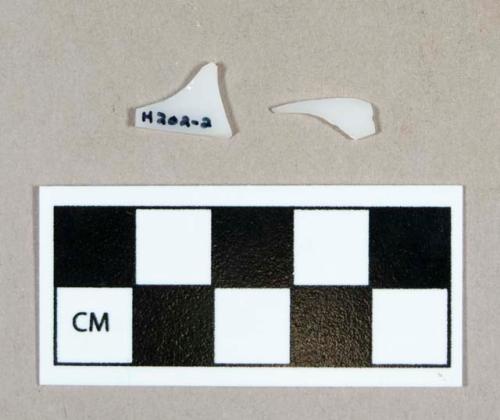 Glass, curved milk-glass body fragments