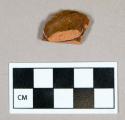 Ceramic, redware body sherd with handle attachment point, clear glaze interior and exterior