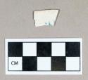 Ceramic, pearlware body sherd, blue underglaze painted, possibly inner portion of shell-edge design